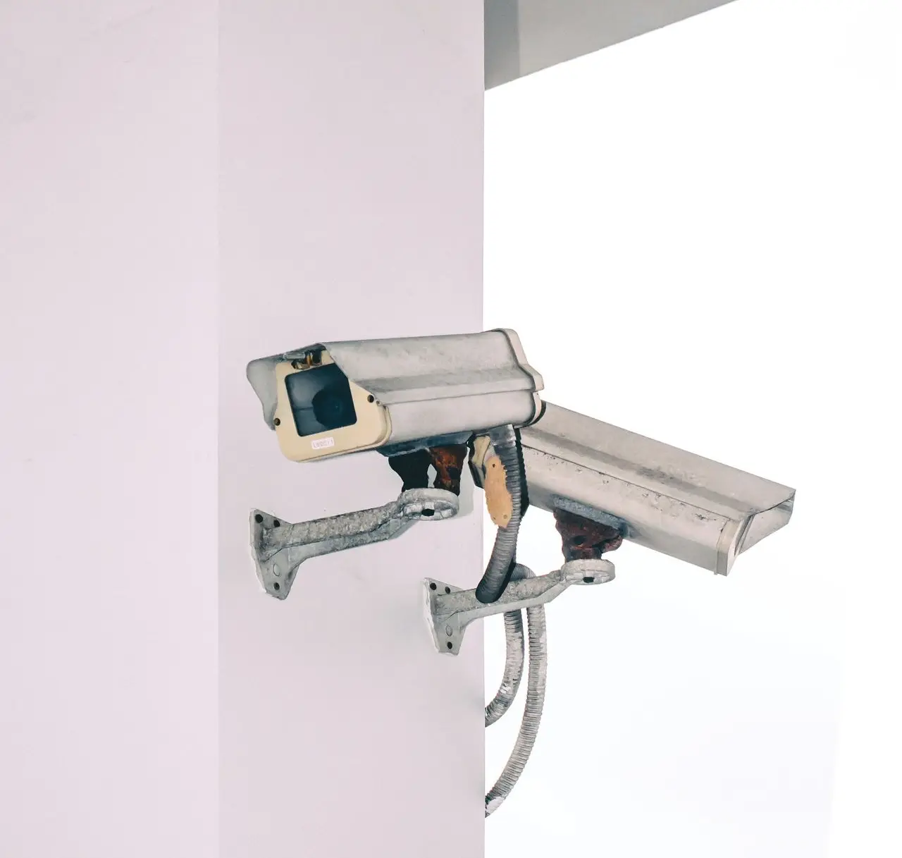 two bullet security camera attached on wall